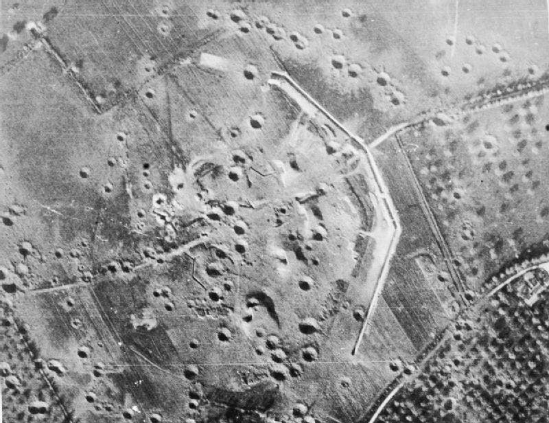 Overhead aerial of the gun battery at Merville (3km east of Ouistreham) consisting of four medium casemates, after air bombardment, May 1944. Bombing failed to penetrate the casemates. Photo by the Imperial War Museums.