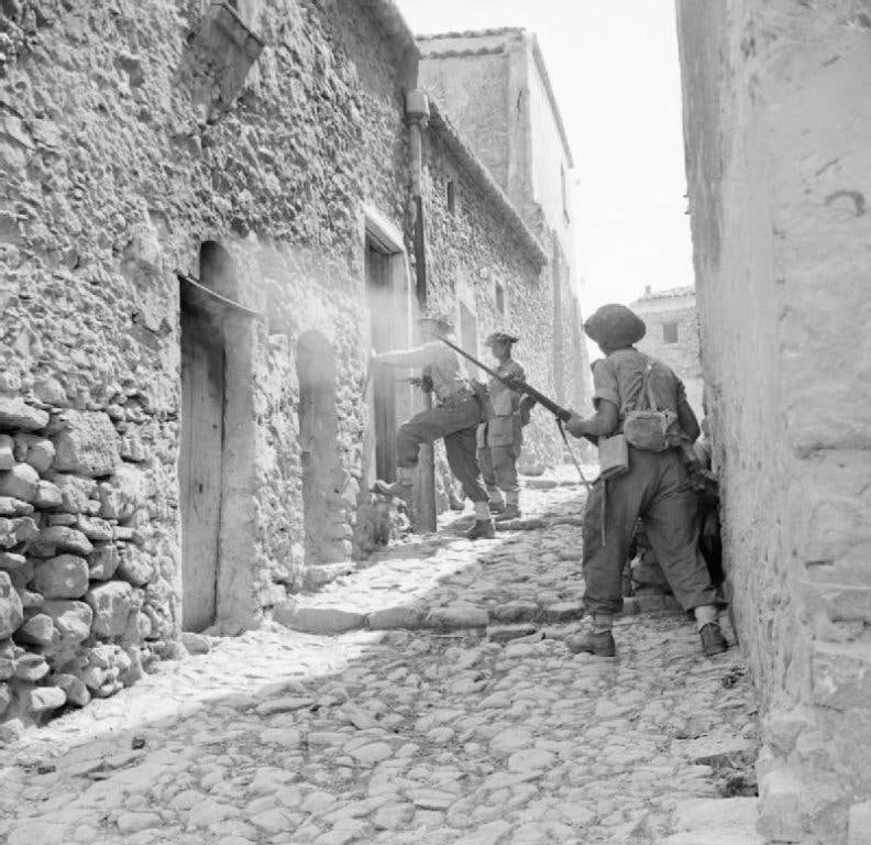 Soldiers with the 38th (Irish) Infantry Brigade search houses in Sicily in 1943. Photo: Public Domain