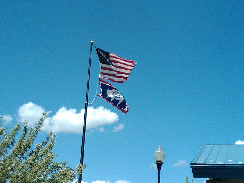State of Wyoming flag flying under the United States Flag. Photo by David Jolley.