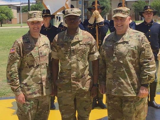 Sgt. Maj. of the Army Dan Dailey and Army Chief of Staff Mark Milley pose with Spc. Cortne K. Mitchell after Mitchell becomes the first soldier in over ten years to legally roll his sleeves in the combat uniform. (Photo: US Army)