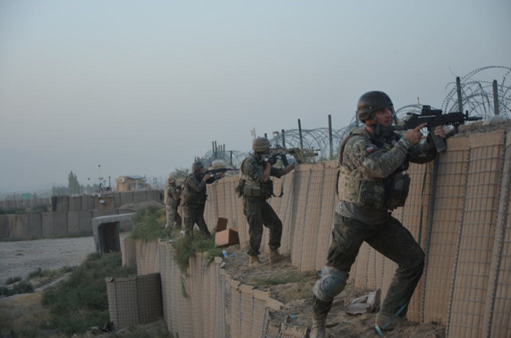 Polish soldiers pull security near a breach in the perimeter wall following a complex attack on Forward Operating Base Ghazni, Aug. 28, 2013. Coalition partners, with the help of the Afghan National Army, defeated the Taliban attack. (Operational photo courtesy of Polish Land Forces)