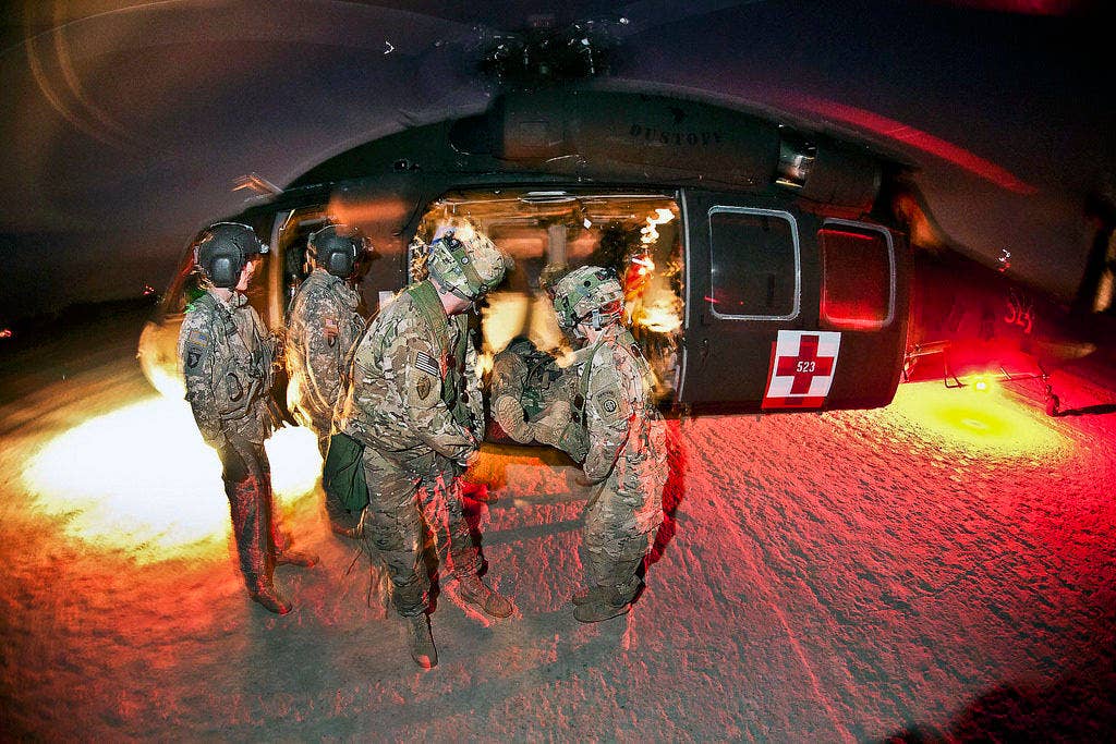 Army medics unload a mock casualty from a UH-60 Black Hawk medevac helicopter during a training exercise. | U.S. Army photo by Sgt. Michael J. MacLeod