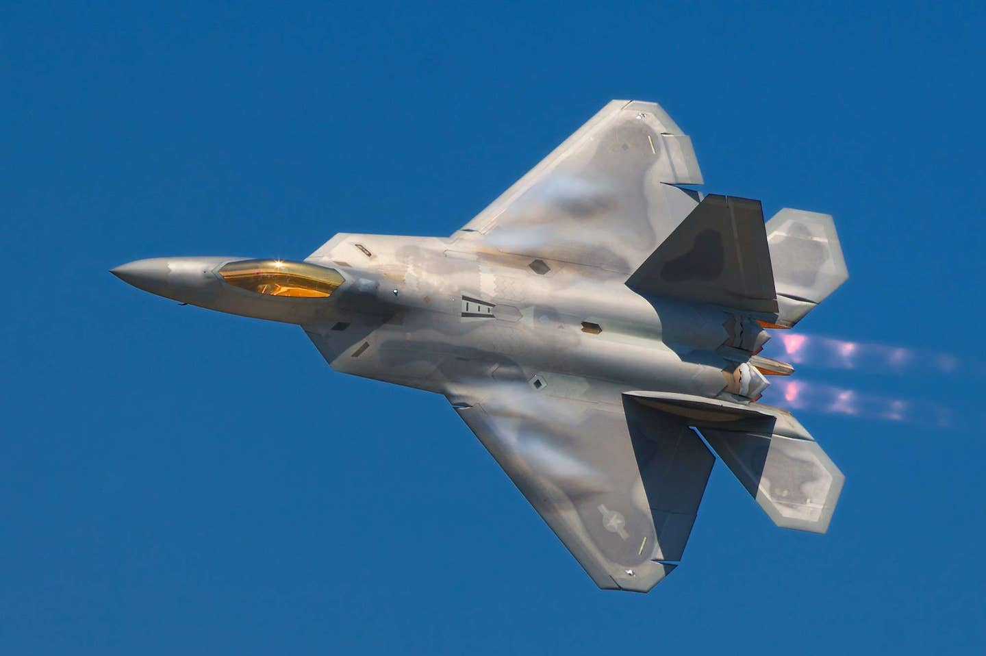 A Lockheed Martin F-22A Raptor fighter streaks by the ramp at the 2008 Joint Services Open House (JSOH) airshow at Andrews AFB. Despite many great performances most of those at the show wanted to see the latest USAF fighter. | Photo by Rob Shenk