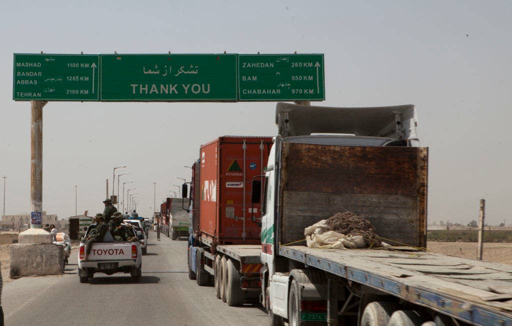 Trucks wait to cross the Afghanistan-Iran border in Zaranj, Afghanistan, May 10, 2011. The crossing is part of a busy trade route between Central Asia and the Middle East. (U.S. Marine Corps photo by Sgt. Mallory S. VanderSchans)