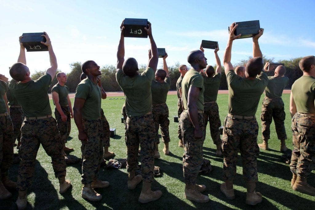 Marine Corps recruits perform ammunition can lifts during the Combat Fitness Test. | Public Domain