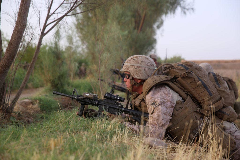 Petty Officer 3rd Class Heston Johnson, corpsman, Bravo Company, 1st Battalion, 7th Marine Regiment, provides security during a mission in Helmand province, Afghanistan, July 4, 2014. (U.S. Marine Corps photo by Cpl. Joseph Scanlan)