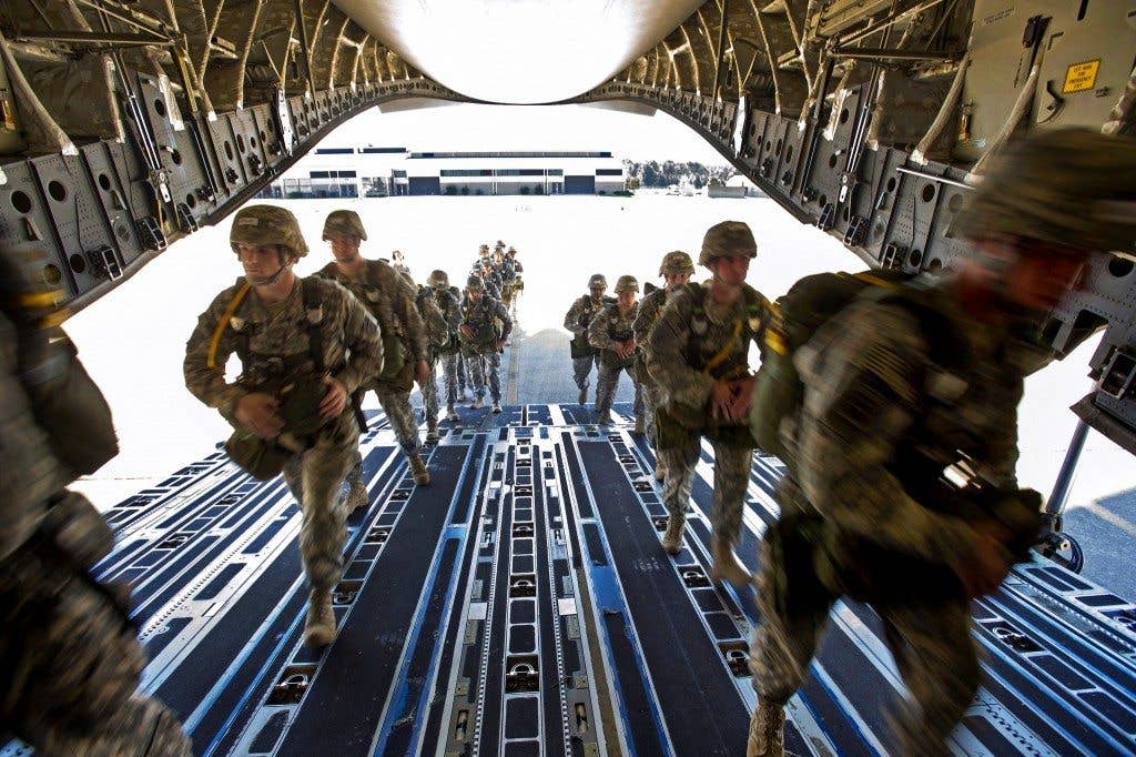 Army paratroopers load onto a C-17 Globermaster III aircraft during an airborne operations exercise on Fort Bragg, N.C., Oct. 11, 2012. The soldiers are assigned to the 82nd Airborne Division. | U.S. Air Force photo by Staff Sgt. Staci Miller