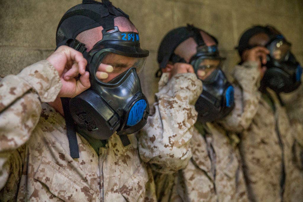 Recruits of Charlie Company, 1st Recruit Training Battalion, break the seals on their gas masks while in the gas chamber Aug. 25, 2015, on Parris Island, S.C. (Marine Corps Photo by Sgt. Jennifer Schubert)