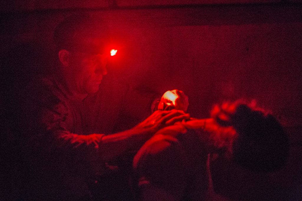 An Army EOD technician attempts to remove a simulated explosive device from a hostage during a training exercise. When you're removing bombs from hostages, you want your hands free. (Photo: US Army Sgt. Ashley Marble)