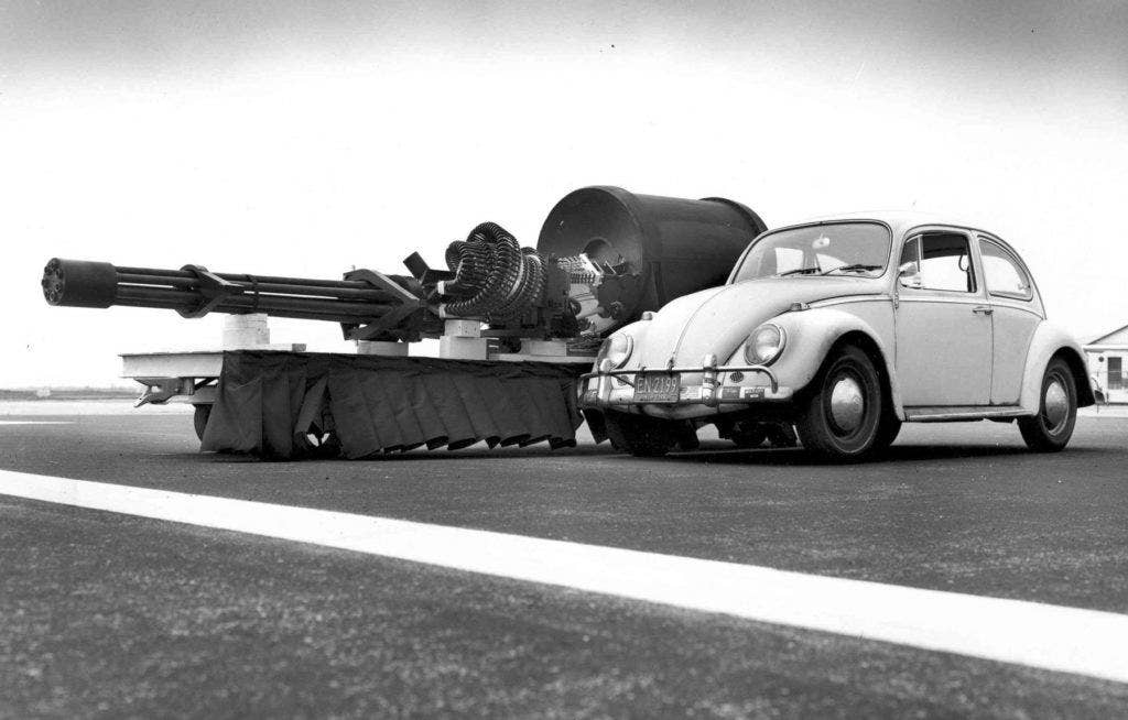 The GAU-8/A Avenger Gatling gun next to a VW Type 1. Removing an installed GAU-8 from an A-10 requires first installing a jack under the aircraft's tail to prevent it from tipping, as the cannon makes up most of the aircraft's forward weight. | US Air Force photo