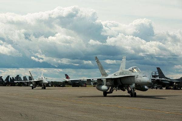 F/A-18C Hornets with Marine Fighter Attack Squadron (VMFA) 314, stationed at Marine Corps Air Station Miramar, California, taxi down the runway at Eielson Air Force Base, Alaska, during Red Flag-Alaska 16-2, June 7, 2016. | US Marine Corps photo by Donato Maffin