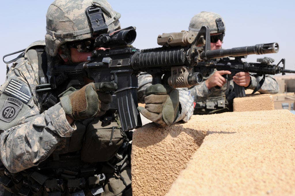 U.S. Army 1st Lt. Branden Quintana, left, and Sgt. Cory Ballentine pull security with an M4 carbine on the roof of an Iraqi police station in Habaniyah, Anbar province, Iraq, July 13, 2011. Ballentine is a forward observer and Quintana is a platoon leader, both with Bravo Company, 2nd Battalion, 325th Airborne Infantry Regiment, 2nd Advise and Assist Brigade, 82nd Airborne Division. | U.S. Army photo by Spc. Kissta Feldner