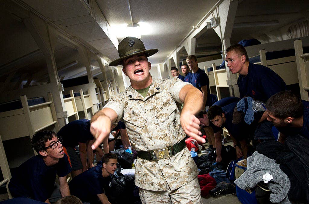 Sgt. Stephen Wills, a drill instructor from Marine Corps Recruit Depot San Diego, instructs Marine enlistees to clean up their gear during a Recruiting Station Seattle pool function at the Yakima Training Center in Yakima, Wash., July 17, 2015. (U.S Marine Corps photo by Sgt. Reece Lodder)