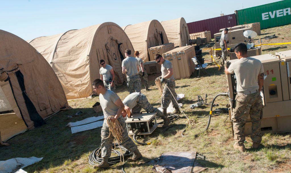 Airmen from the 27th Special Operations Communications, Contracting and Comptroller Squadrons helped build up an exercise area, including fully functioning tents and offices. (U.S. Air Force photo by Staff Sgt. Eboni Reams)