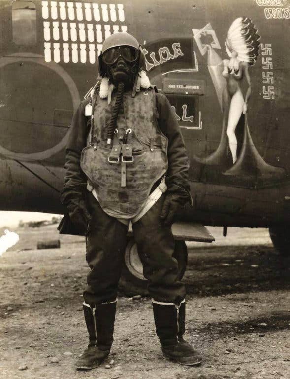 A B-24 Turret Gunner, wearing altitude mask, flak vest, and jacket. (U.S. army photo)