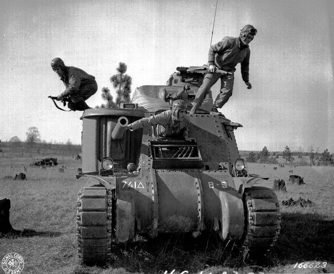 Soldiers rush from their tank during maneuvers in Louisiana. (Photo: US Army Signal Corps)