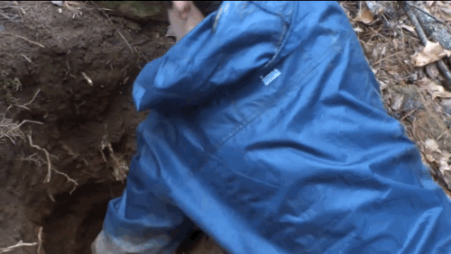 Britain Lockhart plucking a Civil War-era Parrot shell from a three-foot hole. Source: Depths of History, YouTube.
