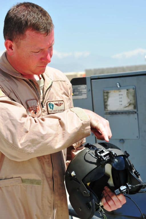 Tech. Sgt. Heath Culbertson, 83rd Expeditionary Rescue Squadron flight engineer, shows where a bullet entered then exited his helmet. &nbsp;(Photo: Capt. Erick Saks, USAF)
