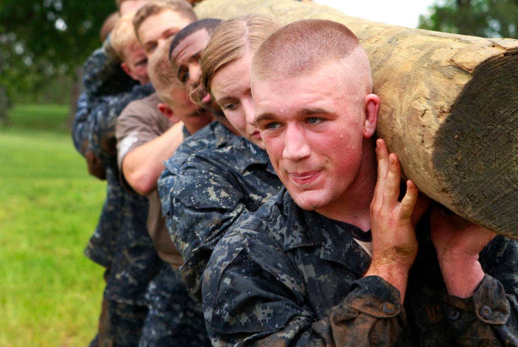 Plebes carry a modified telephone pole during the log PT station of Sea Trials, the capstone training exercise for Naval Academy freshmen. (U.S. Navy photo by Midshipman 3rd Class Dominic Montez)