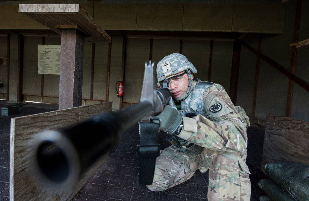 U.S. Army Spc. Demel Cooper, sights his M16 rifle on Feb. 25, 2016 at a military shooting range in Landsthul, Germany. Specialist Cooper and other soldiers at the range wore Advanced Combat Helmets and other personal protective equipment during the training. (DoD photo by Tech Sgt. Brian Kimball)