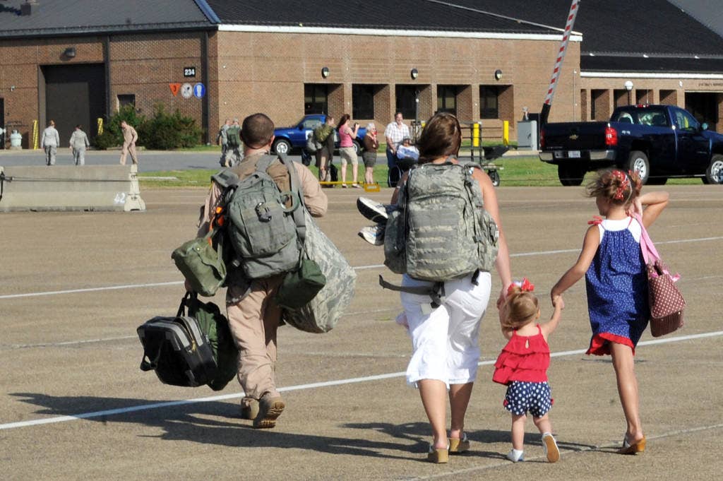Staff Sgt. John Carlin walks off the flightline with his family May 13, 2001, at Little Rock Air Force Base, Ark. Sergeant Carlin is assigned to the 61st Airlift Squadron. | U.S. Air Force photo by Staff Sgt. Chris Willis