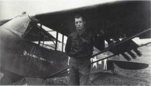 Carpenter next to his L-4. (Library of Congress photo)