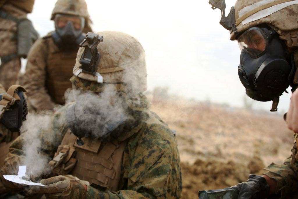 A Marine with Company C , 1st Battalion, 1st Marine Regiment, tests the air for safety after a gas attack August 18, 2016, at Bradshaw Field Training Area, Northern Territory, Australia. (U.S. Marine Corps photo by Sgt. Sarah Anderson)