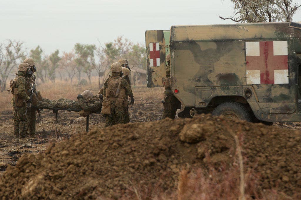 Marines and sailors with 1st Battalion, 1st Marine Regiment, evacuate a simulated casualty during a live fire range August 18, 2016, at Bradshaw Field Training Area, Northern Territory, Australia. (U.S. Marine Corps photo by Sgt. Sarah Anderson)
