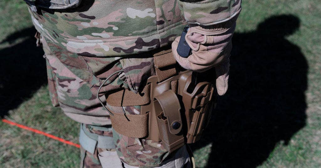 The Serpa holster requires the user to press down on a release button with his trigger finger to draw the weapon. Some argue that configuration contributes to negligent discharges and the Army wants no part of it for the AMTH. (Photo: U.S. Marine Corps)
