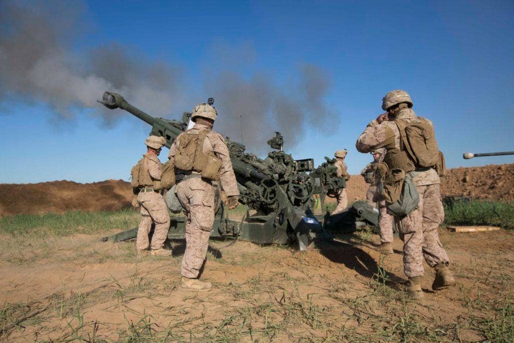 U.S. Marines with Task Force Spartan, 26th Marine Expeditionary Unit (MEU), on Fire Base Bell, Iraq, fire an M777A2 Howitzer at an ISIS infiltration route March 18, 2016. | US Marine Corps photo by Cpl. Andre Dakis