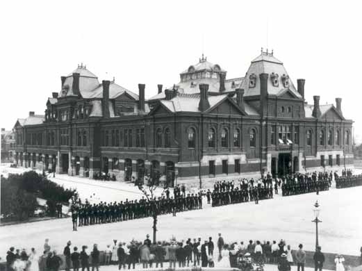Pullman strikers outside Arcade Building in Pullman, Chicago. The Illinois National Guard can be seen guarding the building during the Pullman Railroad Strike in 1894.