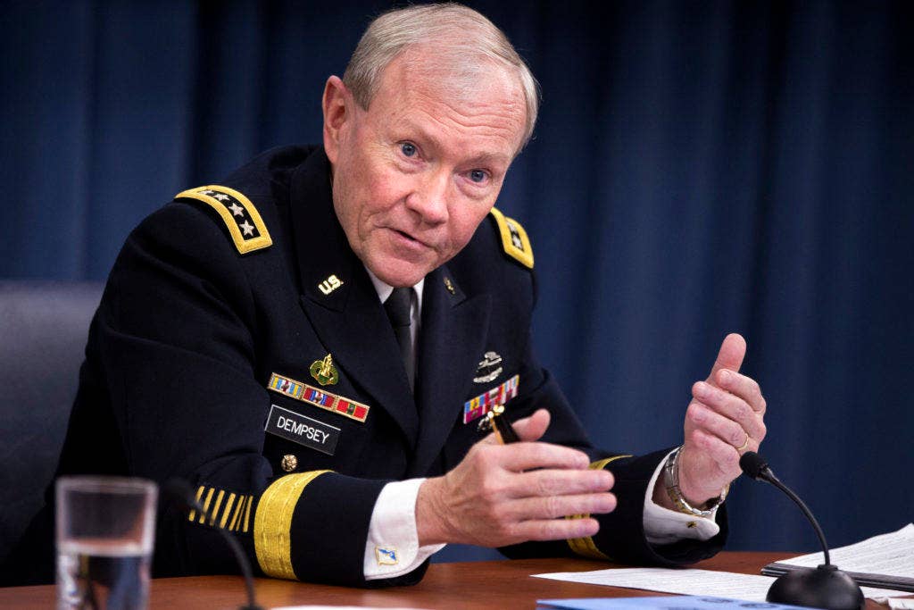 Chairman of the Joint Chiefs of Staff Gen. Martin Dempsey answers a reporter's question during press briefing with Secretary of Defense Chuck Hagel.