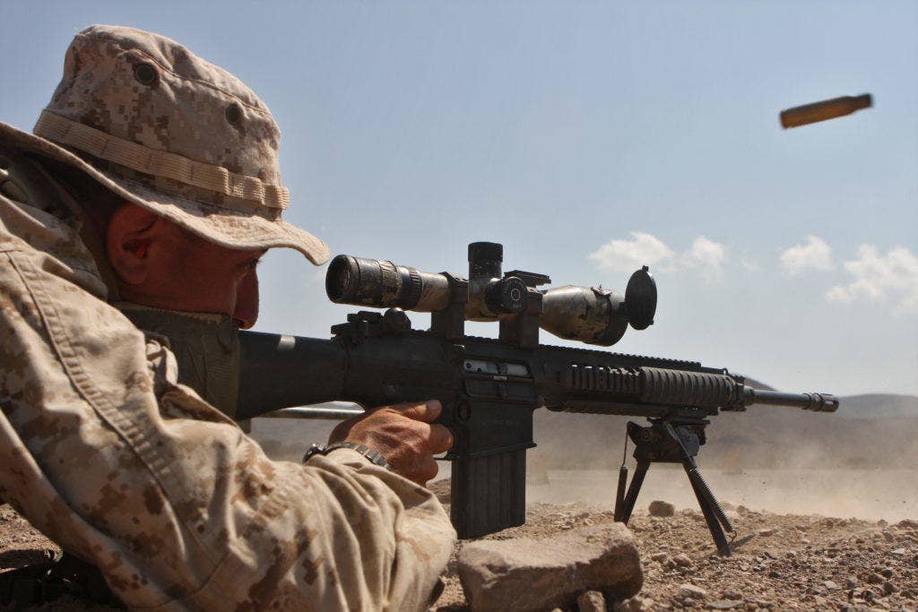 Cpl. Scott P. Ruggio, scout sniper, Scout Sniper platoon, Headquarters and Support Company, Battalion Landing Team 1st Battalion, 9th Marine Regiment, 24th Marine Expeditionary Unit, fires his MK-11 sniper rifle in the first stage of a three-day platoon competition in Djibouti March 25. (Photo: US Marine Corps)