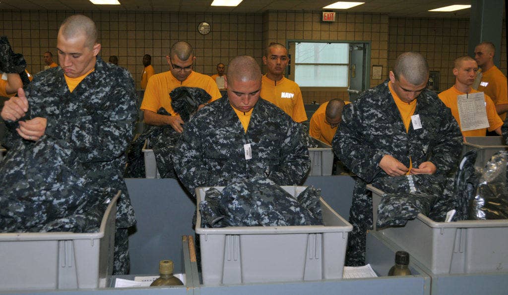 Male recruits try on the navy working uniform at Recruit Training Command. | U. S. Navy photo by Scott A. Thornbloom