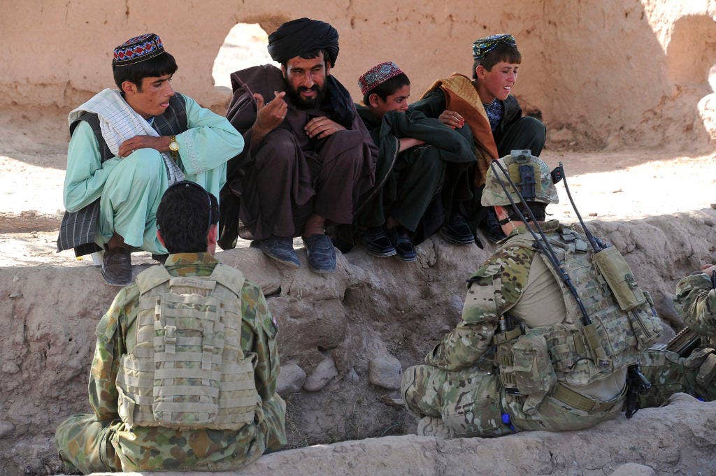 An Afghan man talks with Cpl. William Gill and his interpreter in a village in southern Uruzgan. (DoD Photo by CPL (E-5) Chris Moore Australian Defence Force /Released)
