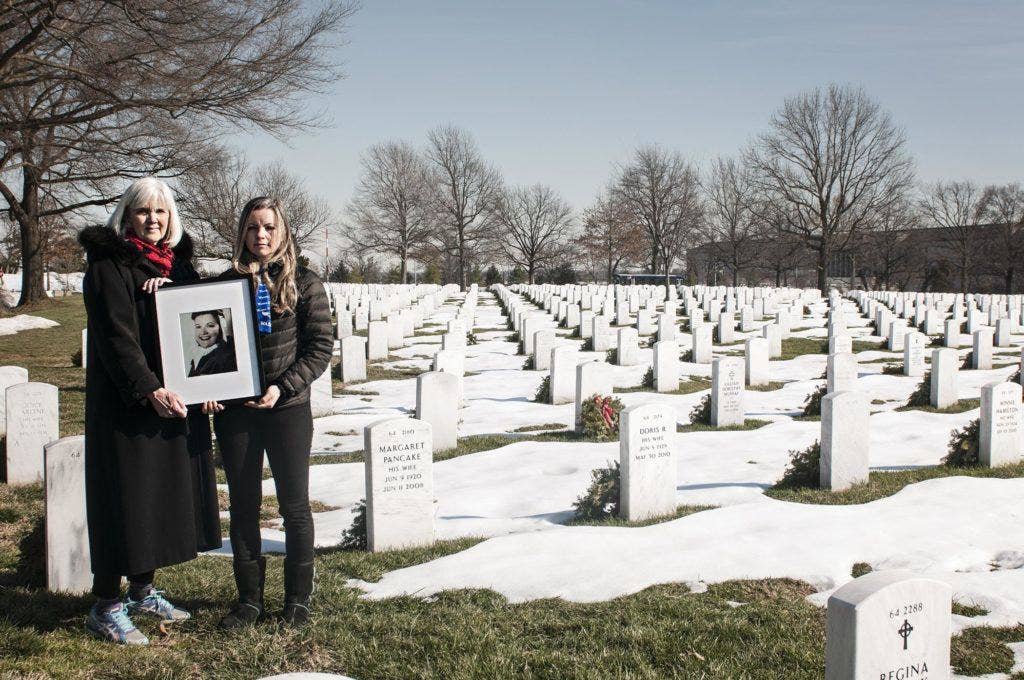 Terry Harmon and Erin Miller, daughter and granddaughter of 2nd Lt. Elaine Harmon, Women Airforce Service Pilot, hold a portrait of her in Arlington National Cemetery, Va. Jan. 31, 2016. | U.S. Air Force photo by Staff Sgt. Katherine Tereyama