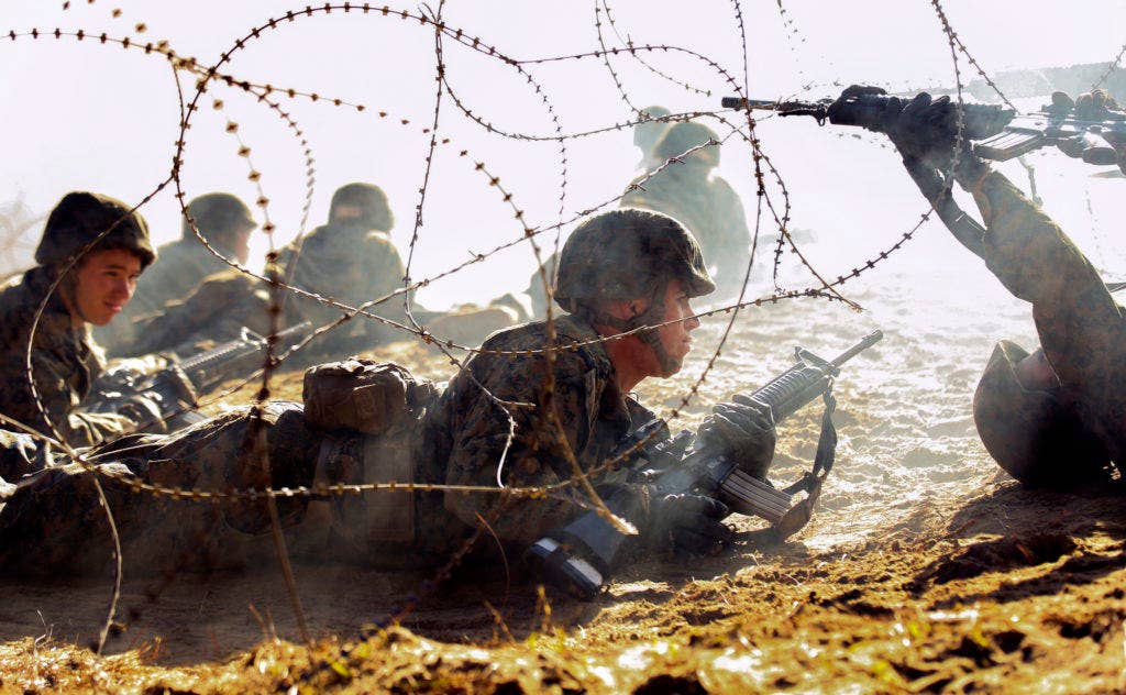 Recruits of India Company, 3rd Recruit Training Battalion, crawl through a simulated battlefield J on Marine Corps Recruit Depot Parris Island, S.C. An incident there on March 18 that involved the death of a recruit is being investigated by NCIS. | U.S. Marine Corps photo by Cpl. Caitlin Brink