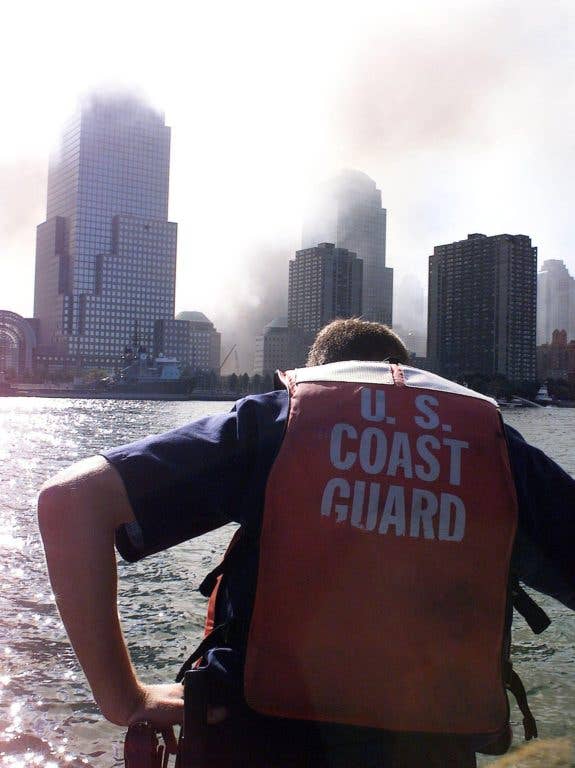 Coast Guard Petty officer Billy Bashaw, from Station Fire Island, bows his head in sorrow onboard his rescue boat Sept. 11. Bashaw has close friends who work in the World Trade Center who are still unaccounted for. (USCG photo by PA2 Tom Sperduto)