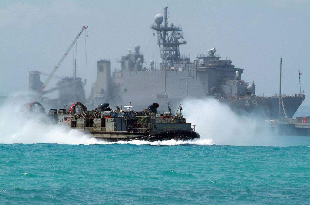 A U.S. LCAC carries U.S. Marine Corps equipment from the dock landing ship USS Harpers Ferry to White Beach Naval Facility in Okinawa, Japan. | US Navy photo by Petty Officer 2nd Class Joshua J. Wahl