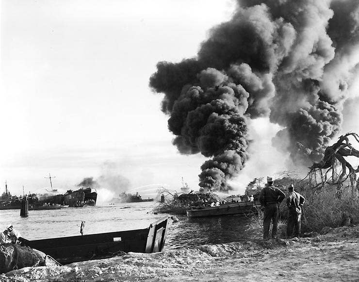 Navy ships continue to burn on May 22, 1944, following the West Loch disaster the previous day at Pearl Harbor, Hawaii. The center plume of smoke is coming from LST-480 whose wreckage is still present at West Loch. (Photo: U.S. Army Signal Corps)