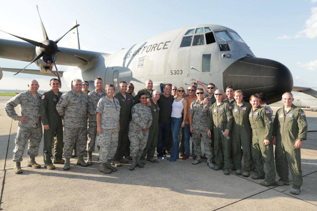 Kurt Russell, Pete Berg, and Kate Hudson pose with assembled airmen in front of a WC-130J aircraft. | Photo courtesy of Lionsgate