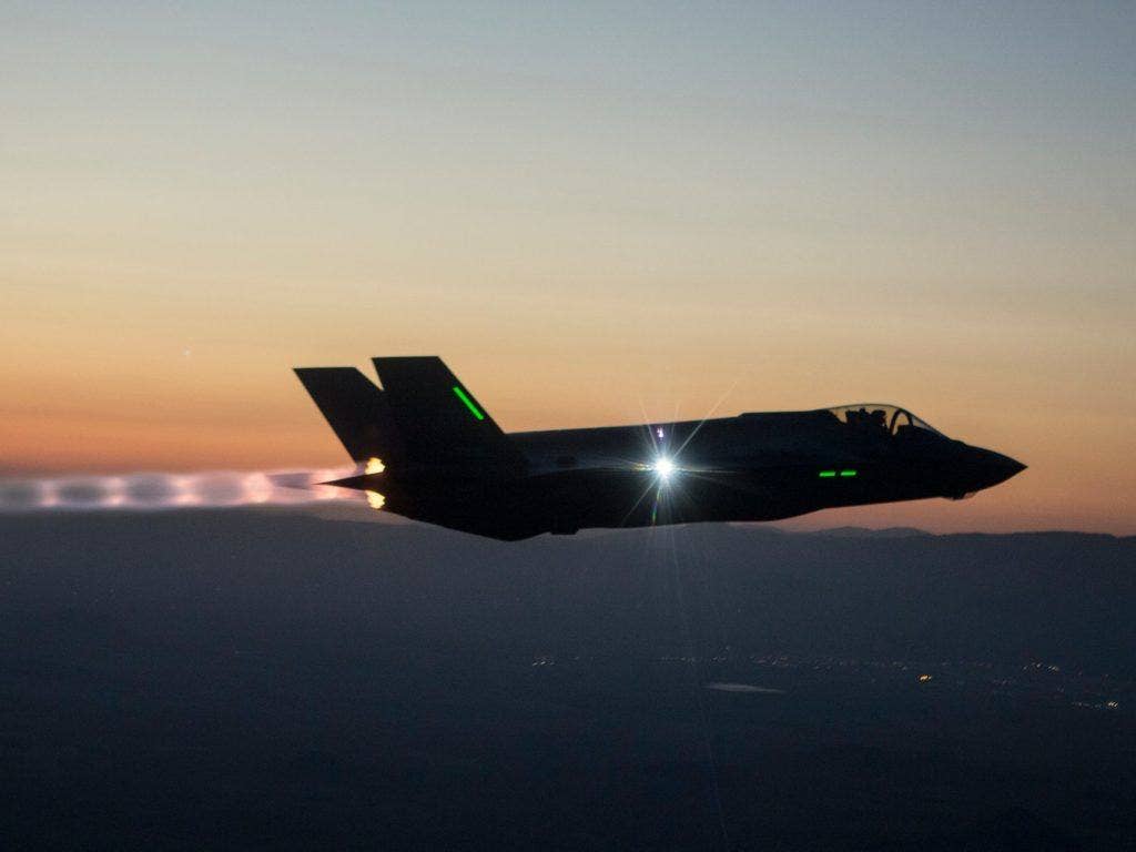 An F-35A conventional takeoff and landing aircraft flying with its afterburner over Edwards Air Force Base on a night mission in 2013. | Courtesy of Lockheed Martin
