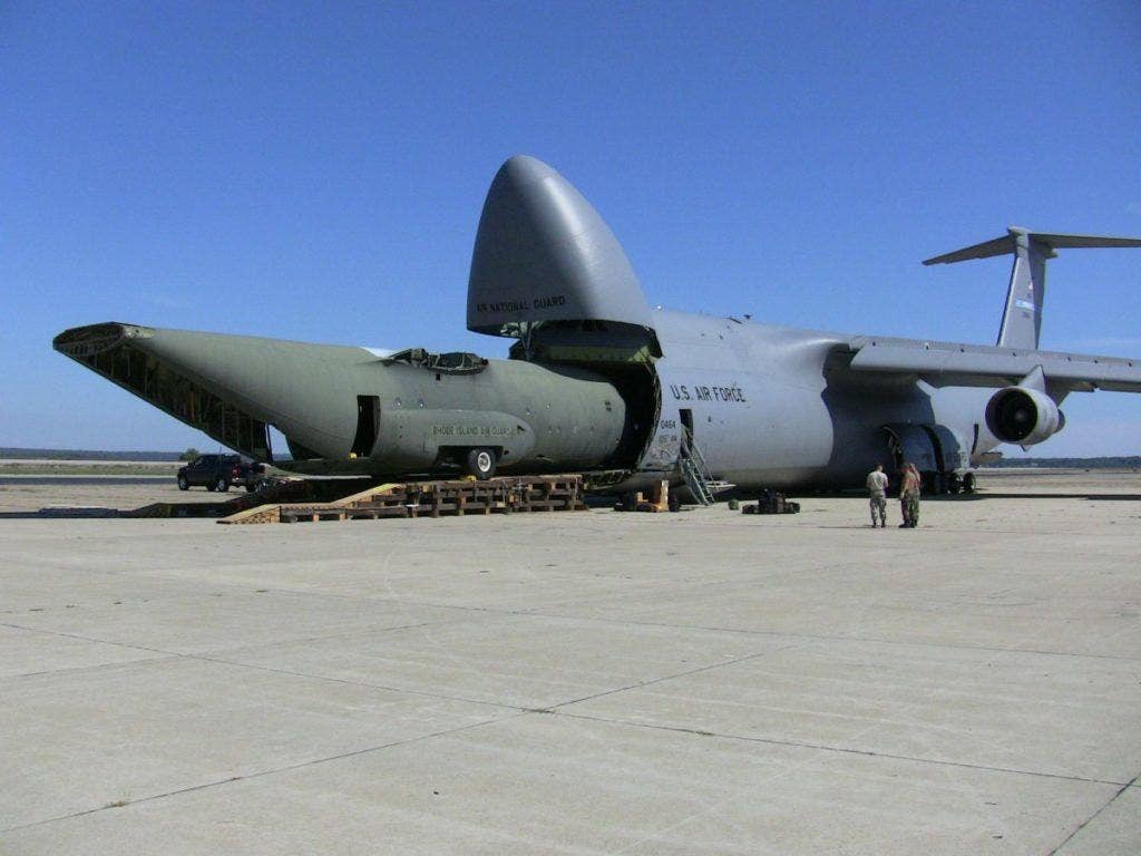 A C-130 Hercules training fuselage is loaded into a C-5 Galaxy for transport to Stratton Air National Guard Base, New York. This was the first time a C-5 transported a C-130 fuselage. (U.S. Air Force photo by Tech. Sgt. Ty Moore)