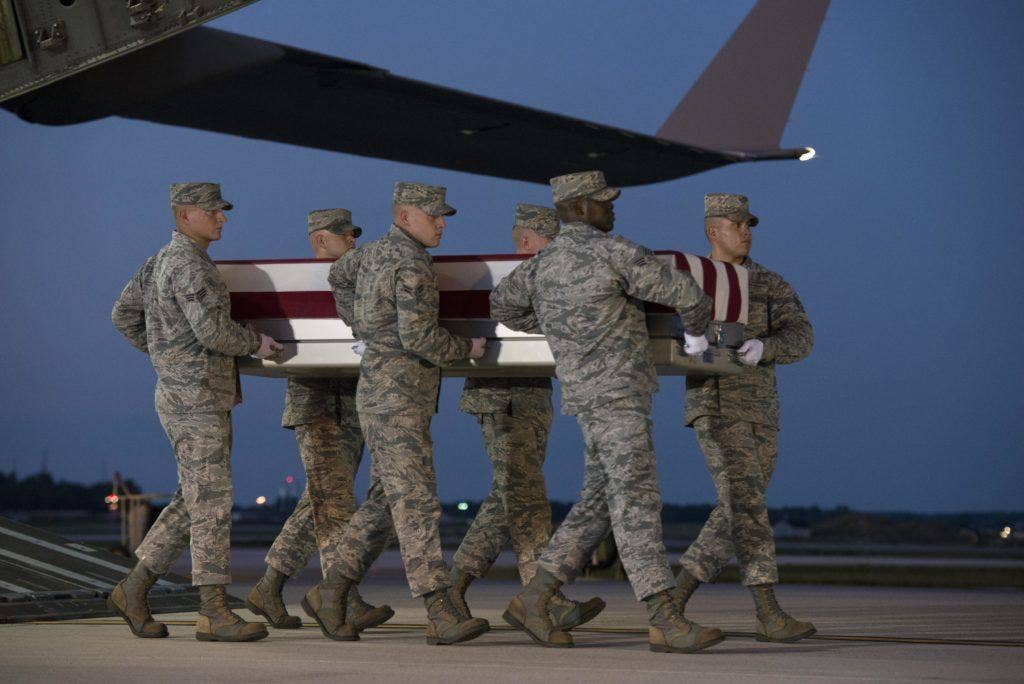 An Air Force carry team carries the remains of Maj. Troy Gilbert Oct. 3, 2016, at Dover Air Force Base, Del. | U.S. Air Force Photo by Senior Airman Aaron J. Jenne