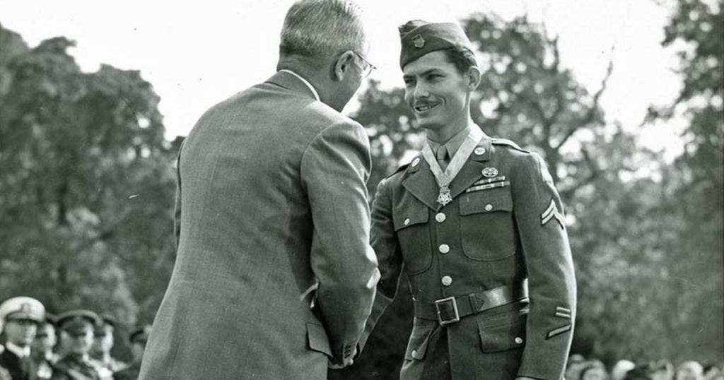President Truman shakes hands with Cpl. Desmond Doss after presenting the soldier with the Medal of Honor.
