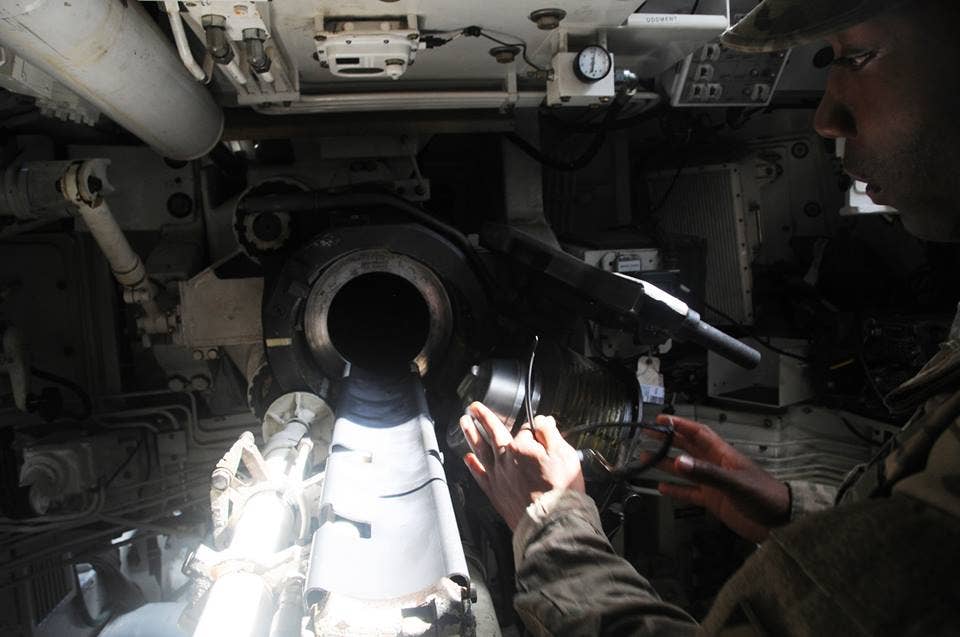 A Paladin crew member inspects the firing chamber of his vehicle. Armored vehicles like the Paladin are cramped with few windows and openings, but new technologies could let the crew see the battlefield around them. (Photo: U.S. Army Staff Sgt. Hector Corea)