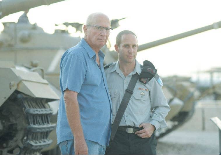 Zvika Greengold (left) and Lt. Col. Aryeh Berger, commander of the 74th Armored Battalion, pose at the Armored Corps Memorial at Latrun in 2015. (IDF photo)