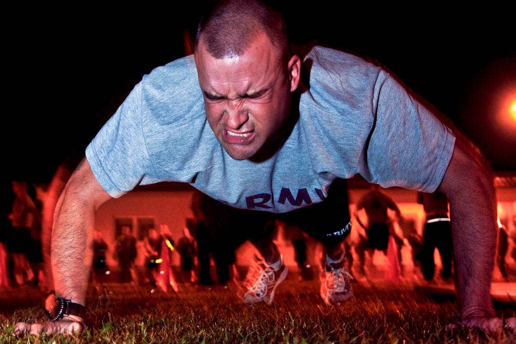 U.S. Army Staff Sgt. Matthew Senna, assigned to Joint Multinational Training Command, performs push-ups during the Army Physical Fitness Test at U.S. Army Europe's Best Warrior Competition in Grafenwoehr, Germany, July 30, 2012. (Photo from U.S. Army)