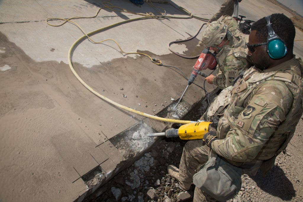 U.S. Air Force Senior Airmen Timothy Williams, assigned to the 1st Expeditionary Civil Engineering Group, operates a jackhammer on a runway during repair operations at Qayyarah, West Airfield, Iraq, Oct. 7, 2016. (Photo and cutline: U.S. Army Spc. Christopher Brecht)