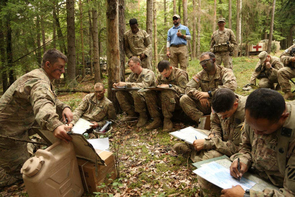 U.S. Soldiers of Rider Company, 2nd Battalion, 7th Infantry Regiment, 1st Armored Brigade record information while conducting a brief during exercise Combined Resolve VII at the U.S. Army's Joint Multinational Readiness Center in Hohenfels Germany, Sept. 11, 2016. The exercise is designed to train the Army's regionally allocated forces to the U.S. European Command. Combined Resolve VII includes more than 3,500 participants from 16 NATO and European partner nations. (U.S. Army photo by Pfc. Caleb Foreman)